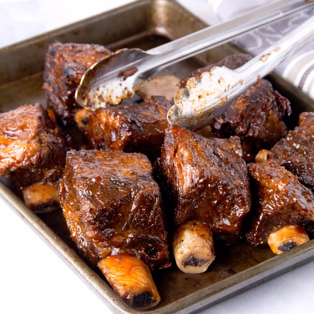 How do you cook Short ribs with peach BBQ sauce?