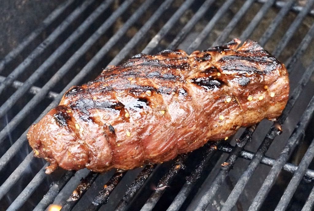 How do you sear beef tenderloin before grilling?